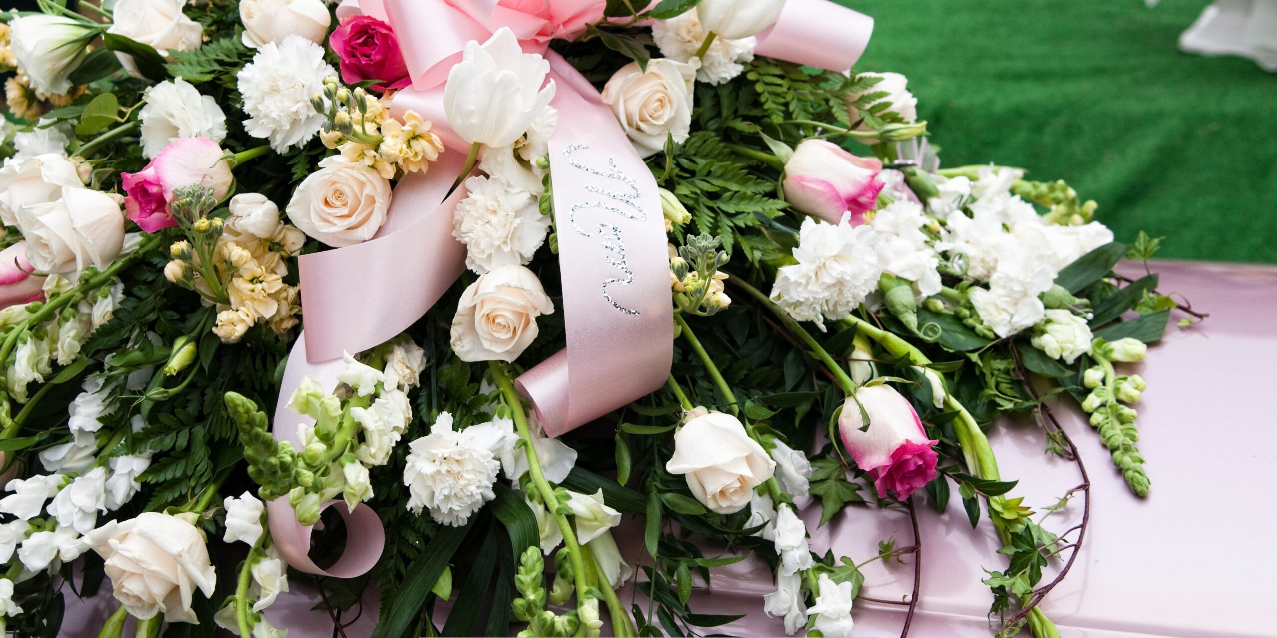 Pink and white funeral flowers symbolizing compassion, remembrance, and dignified cremation services.